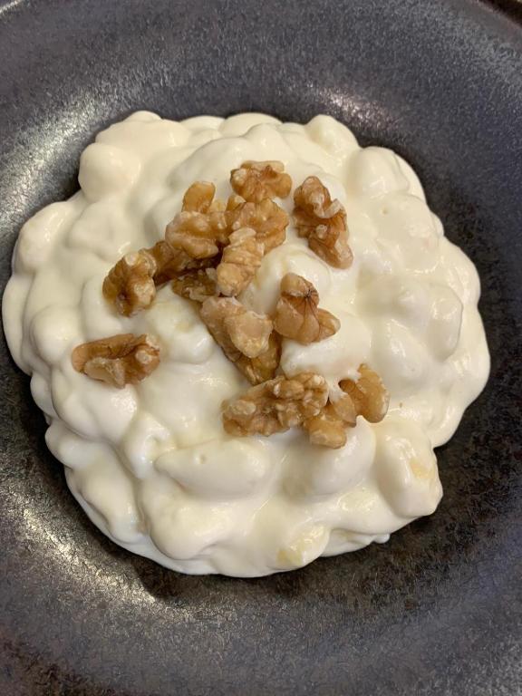 a doughnut with white frosting and nuts on it at Chalet Hotel Dragon in Breuil-Cervinia