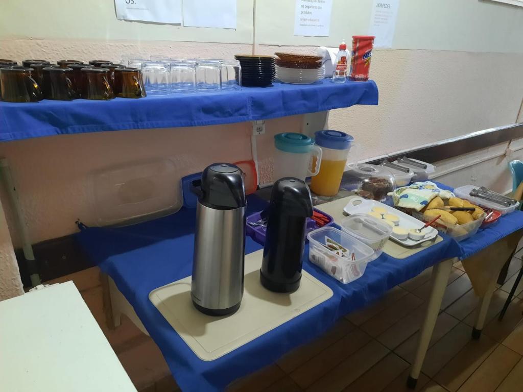 a blue table with a coffee maker on it at HOTEL TROPICAL in Cuiabá