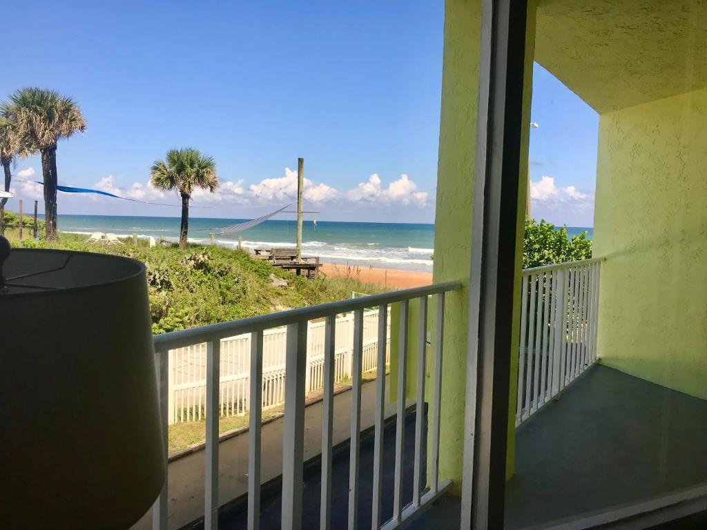 a balcony with a view of the beach at Coastal Sands - Ocean View at Symphony Beach Club! in Ormond Beach