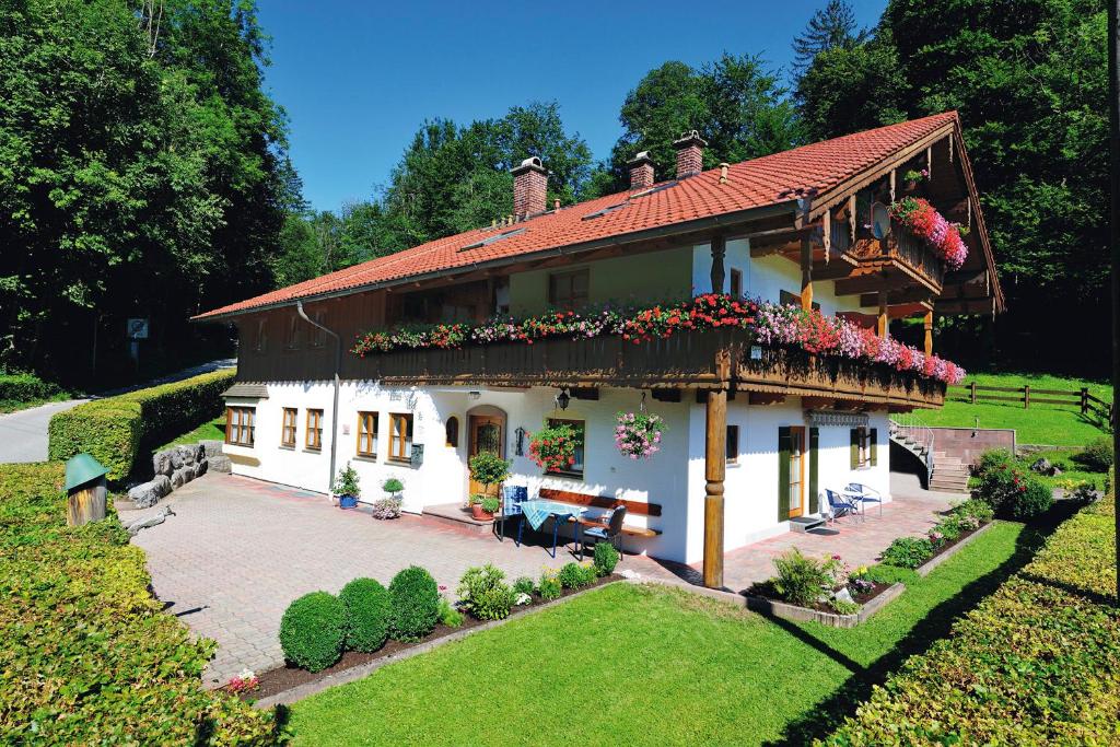 a large house with flowers on the side of it at Haus Vogl in Berchtesgaden