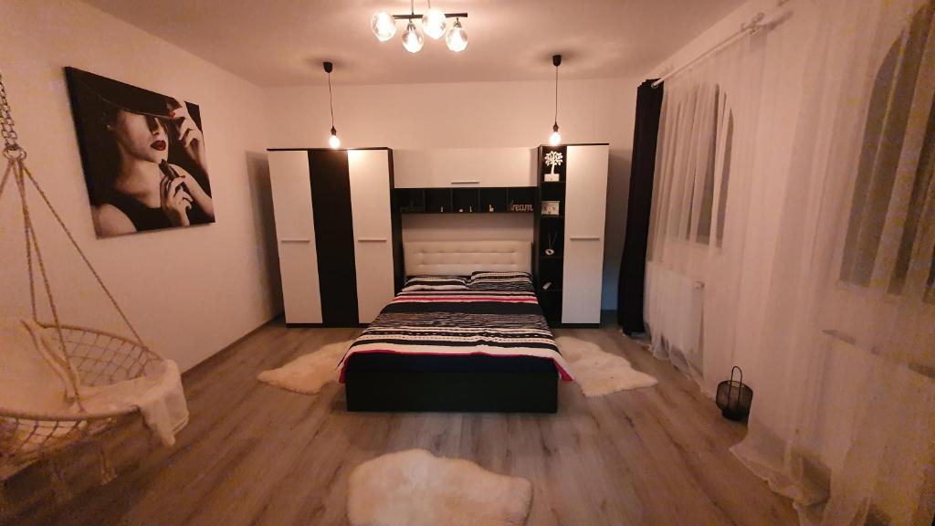 a bedroom with two beds and a swing at Casa mica Resita in Reşiţa