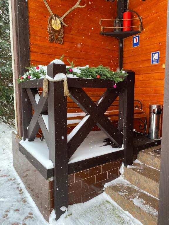 a wooden gate with a christmas wreath on it at Guest house Shulc in Mizhhirya