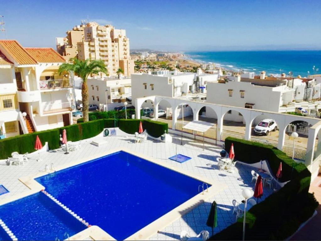 Pogled na bazen u objektu Apartment with pool, sea views & balcony less than 10min walk to La Mata Beach! ili u blizini
