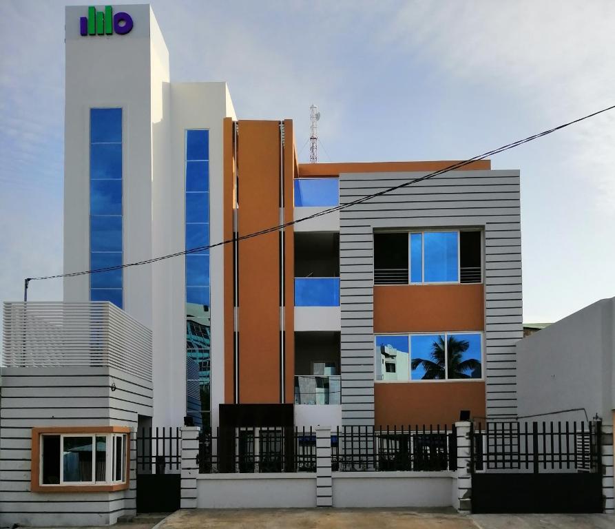 a building with a fence in front of it at IMOLEASE HUBERT Sainte Rita in Cotonou