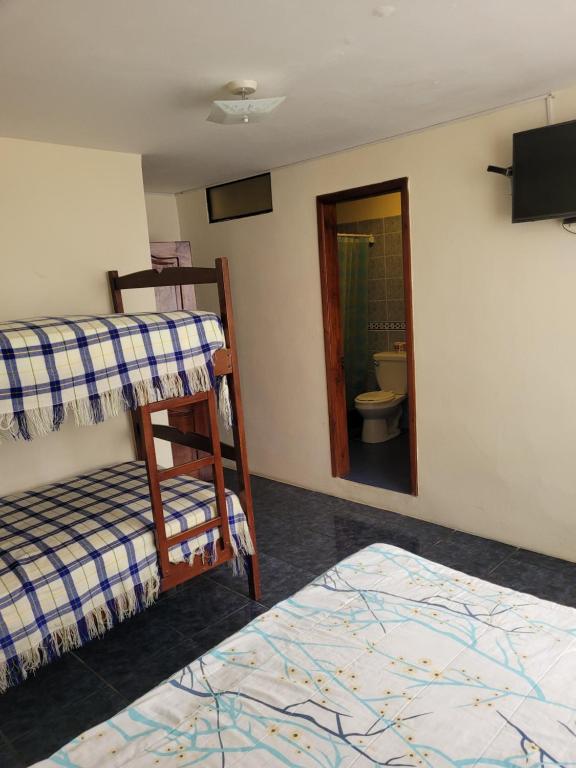 Postel nebo postele na pokoji v ubytování Hostal Haziel