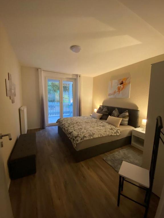 a bedroom with a bed and a large window at ferienwohnungen.ruhla in Ruhla