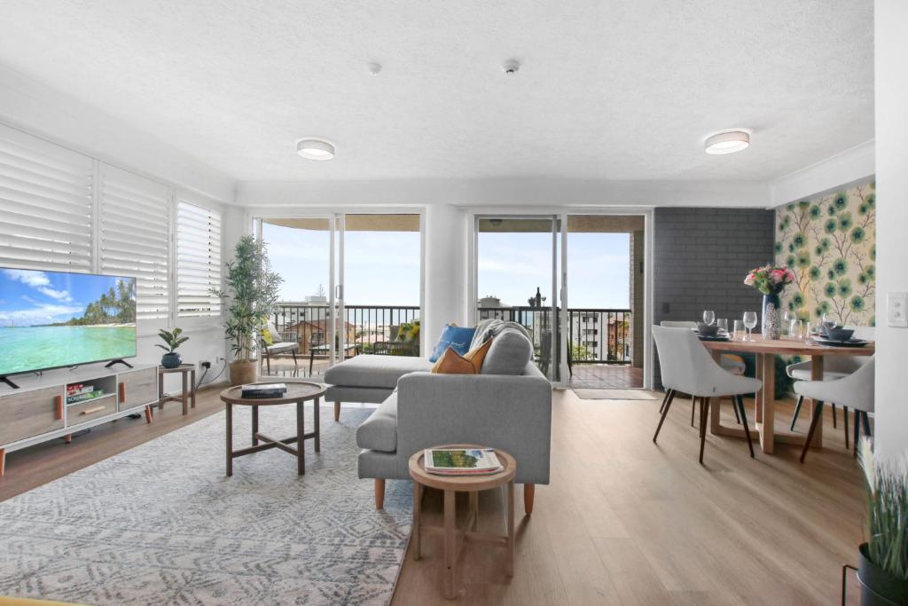 a living room with a couch and a tv at Canberra Heights Unit 2 35 Canberra Tce Kings Beach in Caloundra