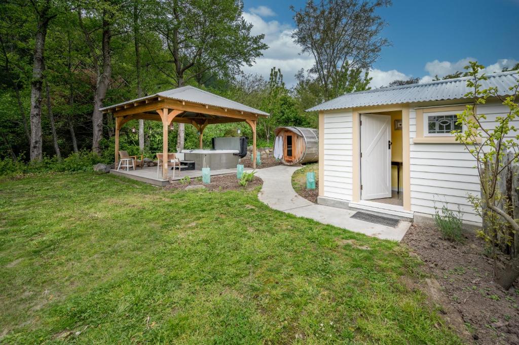 a backyard with a gazebo and a shed at Matagouri Cottage - Port Levy Holiday Home in Port Levy