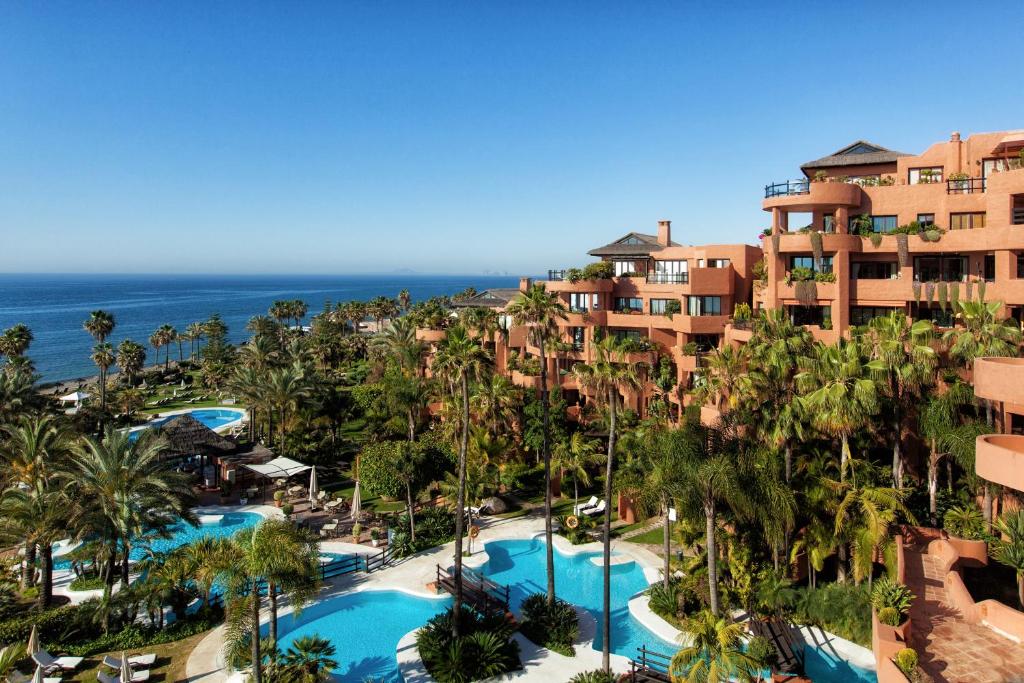 an aerial view of a resort with palm trees and pools at Bahía Beach Apartments Estepona in Estepona