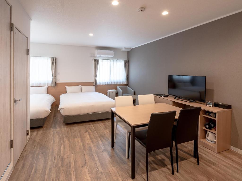 Postel nebo postele na pokoji v ubytování HOTEL R9 The Yard Hitachinaka
