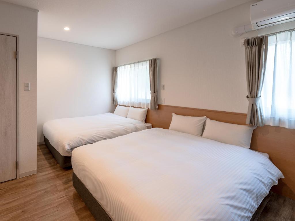 Postel nebo postele na pokoji v ubytování HOTEL R9 The Yard Hitachinaka