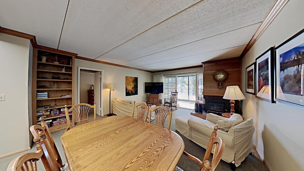 a living room with a table and chairs and a couch at Lakeview 826 Condo #108 Condo in Mammoth Lakes