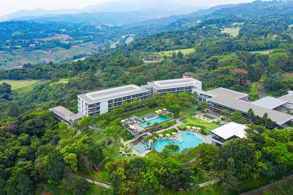 an aerial view of a resort with a swimming pool at Royal Tulip Gunung Geulis Resort and Golf in Bogor