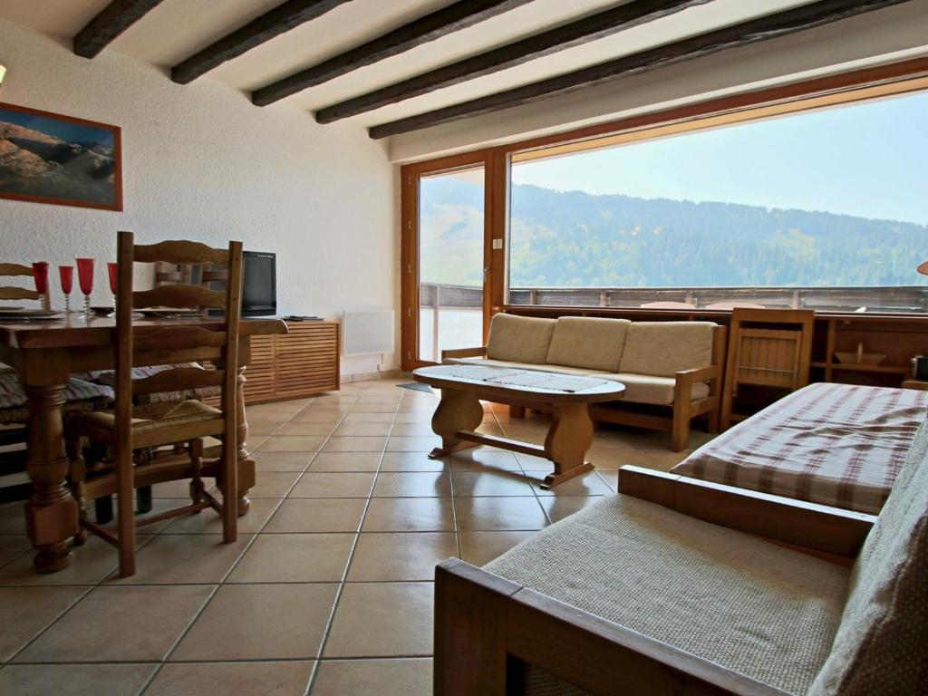 a living room with a couch and a table at Appartement Chamrousse, 3 pièces, 6 personnes - FR-1-340-204 in Chamrousse