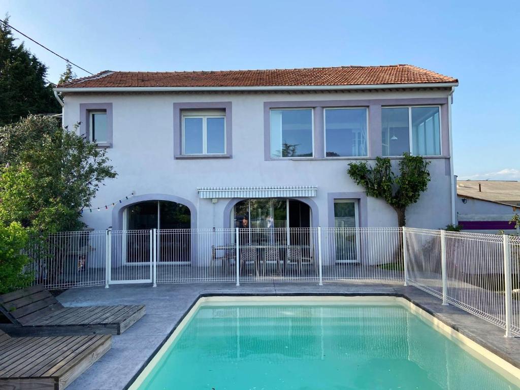 ein Haus mit einem Pool vor einem Haus in der Unterkunft Villa de 4 chambres avec piscine privee jacuzzi et jardin clos a Saint Privat des Vieux in Saint-Privat-des-Vieux