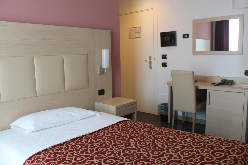 Postel nebo postele na pokoji v ubytování Hotel Eridano