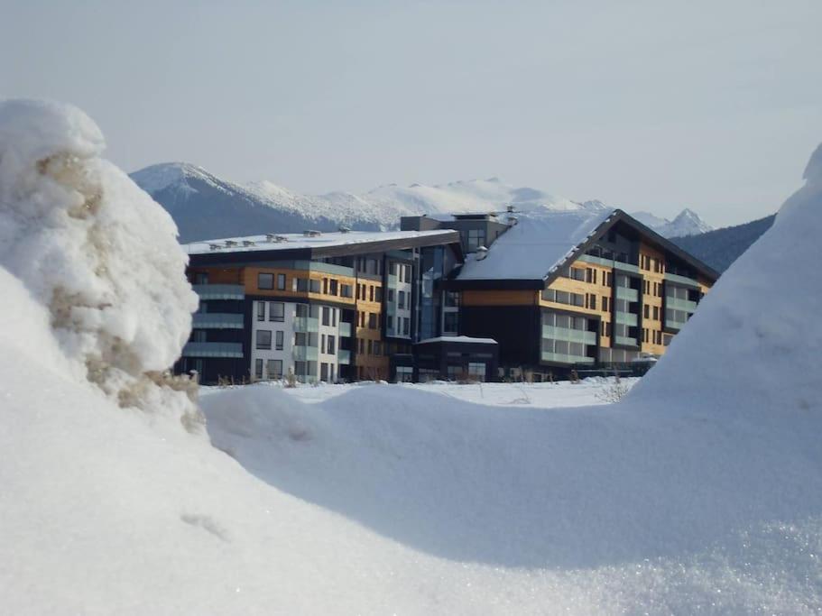 a pile of snow in front of a large building at Aspen Heights 4 bed studio in Bansko