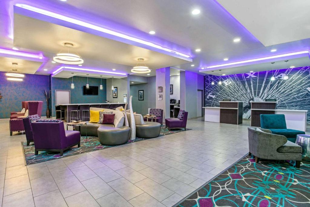 a lobby with purple and purple chairs and a waiting room at La Quinta by Wyndham Lubbock South in Lubbock