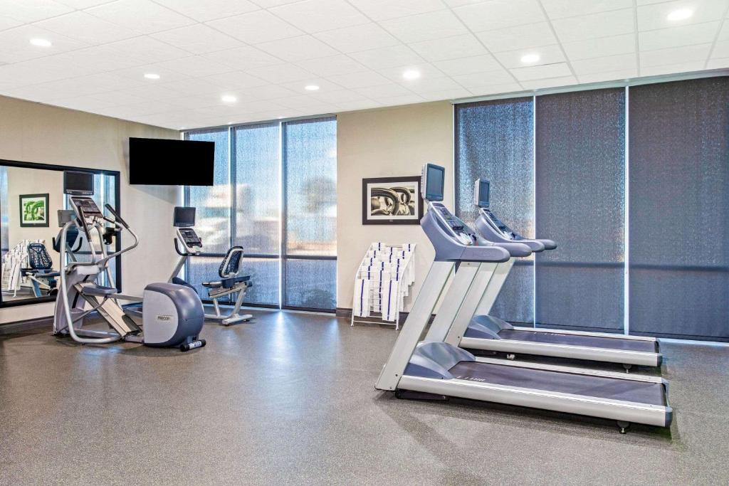 a gym with treadmills and machines in a room at La Quinta by Wyndham Lubbock South in Lubbock