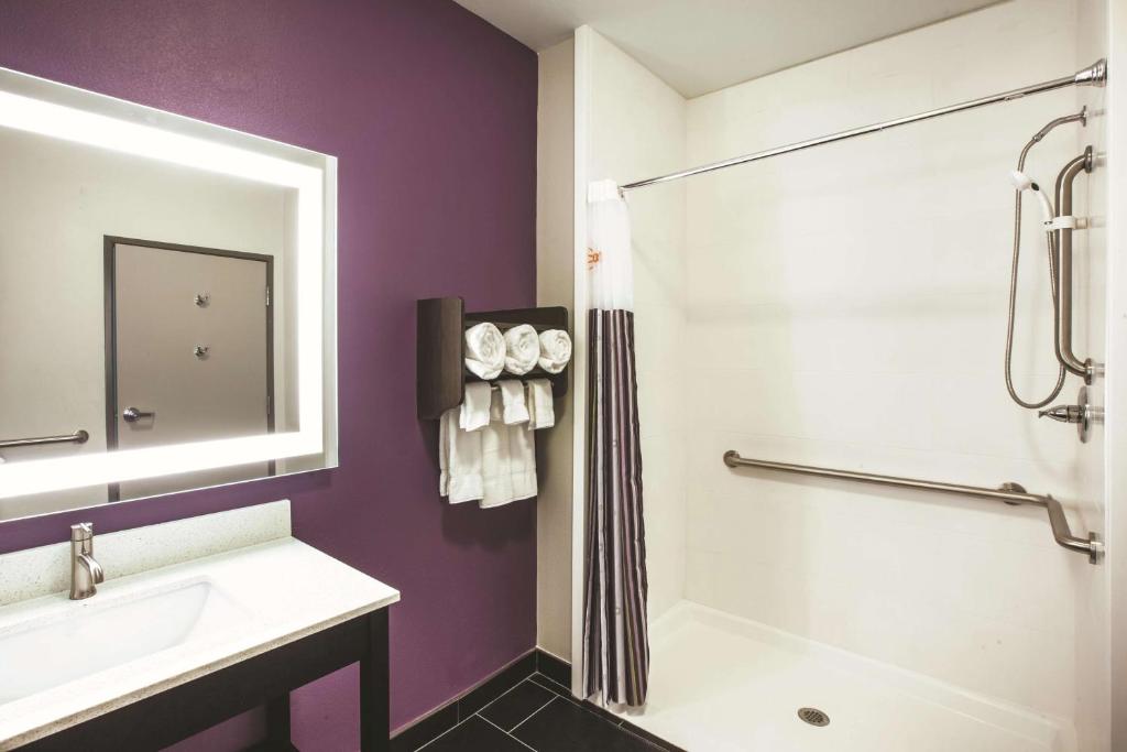 a bathroom with a sink and a shower at La Quinta by Wyndham Lubbock South in Lubbock