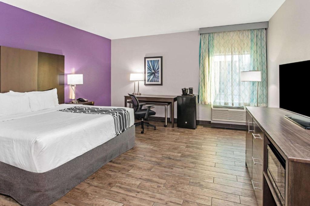 a hotel room with a bed and a desk at La Quinta by Wyndham Lubbock South in Lubbock