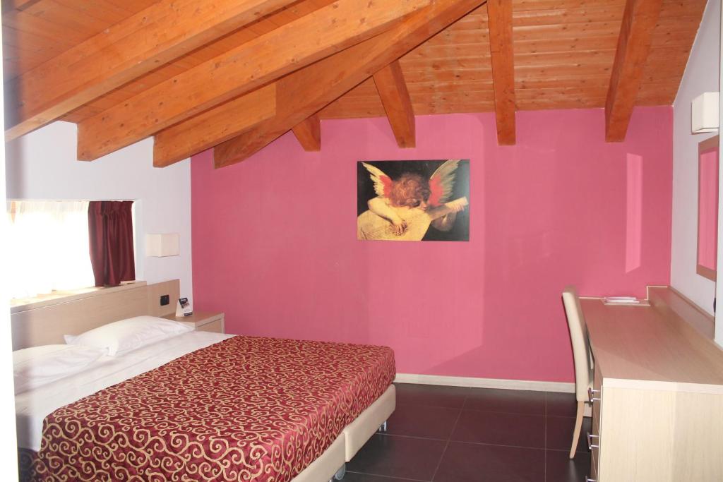 Postel nebo postele na pokoji v ubytování Hotel Eridano
