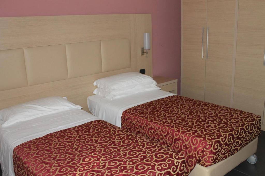 Postel nebo postele na pokoji v ubytování Hotel Eridano