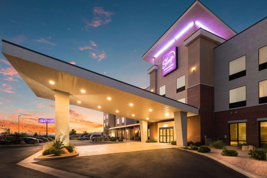 a hospital building with a lit up sign on it at Sleep Inn & Suites Hurricane Zion Park Area in Hurricane