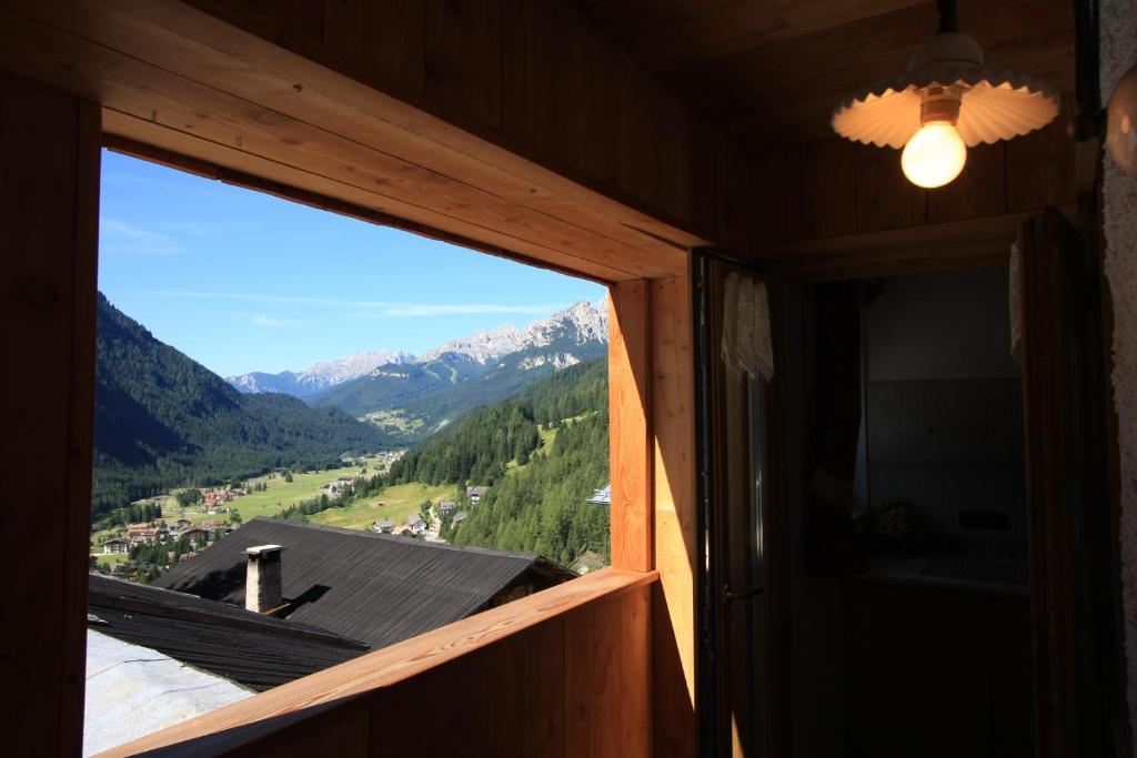 a room with a window with a view of mountains at Chalet Pian in Campitello di Fassa