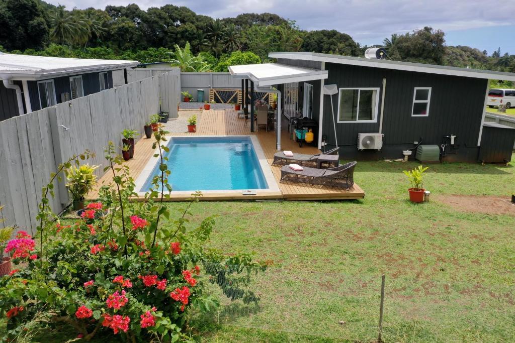 a tiny house with a swimming pool in a yard at Te Etu Villa 1 in Rarotonga