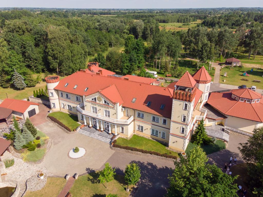 an aerial view of a large mansion with a red roof at Dwór Dziekanów in Zielonki
