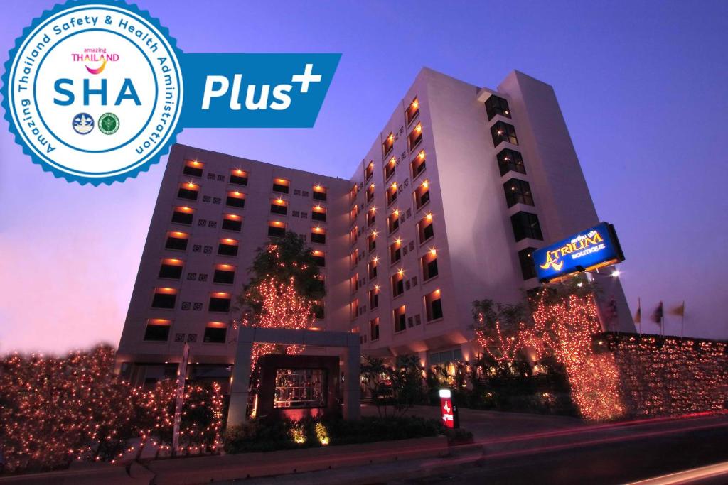 a hotel with christmas lights in front of a building at Atrium Boutique Hotel in Bangkok