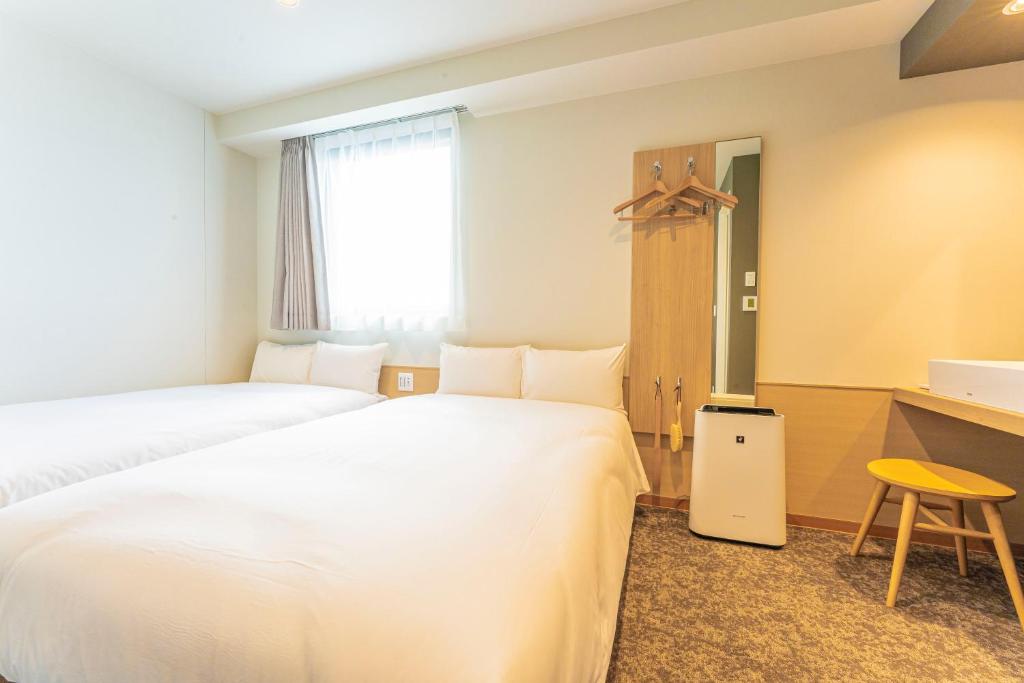 Postel nebo postele na pokoji v ubytování CVS Bay Hotel