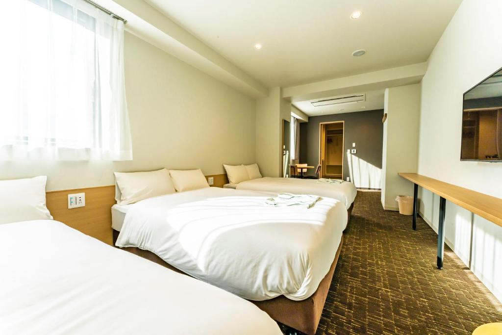 Postel nebo postele na pokoji v ubytování CVS Bay Hotel