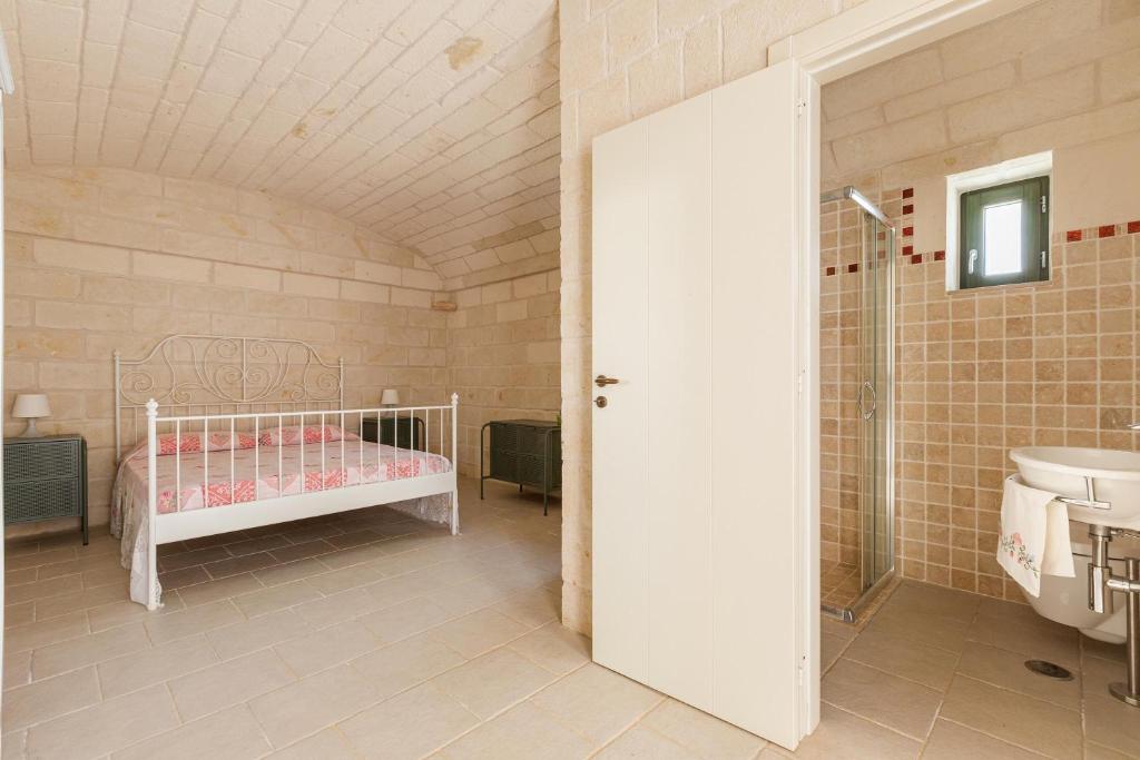 Łóżko lub łóżka w pokoju w obiekcie Il Trullo di Erna by BarbarHouse