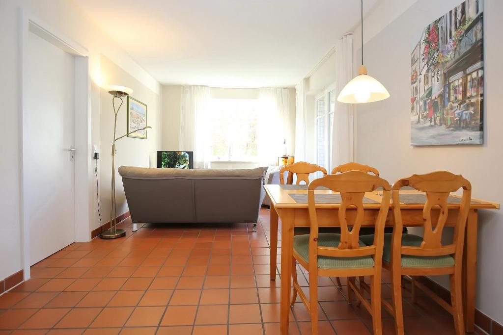 a dining room with a table and chairs at Dünenblick Wohnung 20 in Boltenhagen