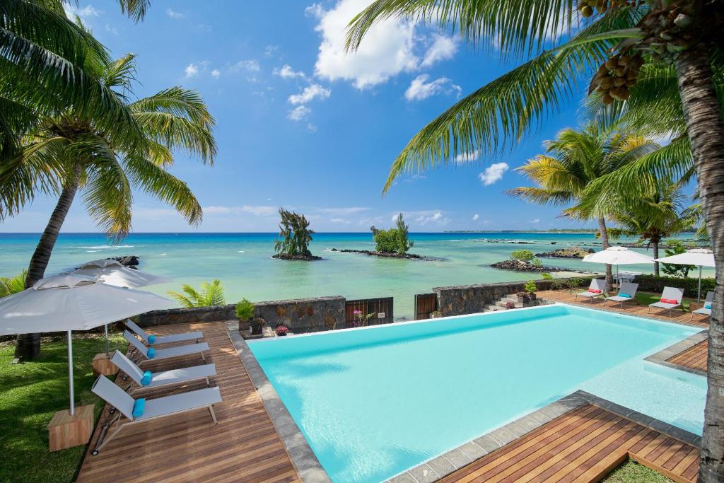 an infinity pool with the ocean in the background at Bel Azur Beachfront Suites and Penthouses by LOV in Trou aux Biches
