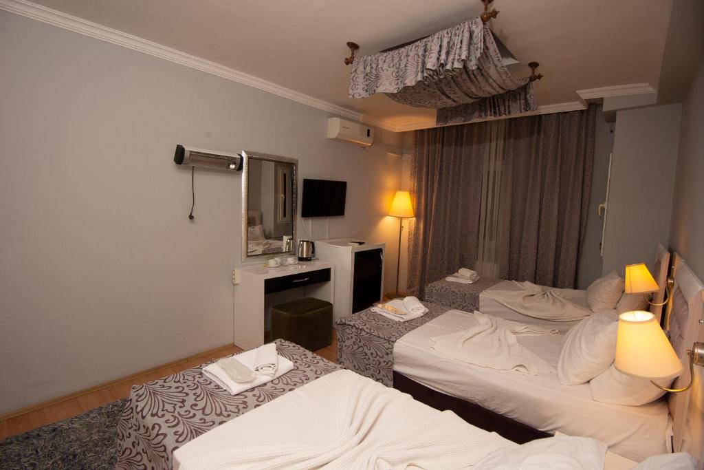 Postel nebo postele na pokoji v ubytování SRF Hotel