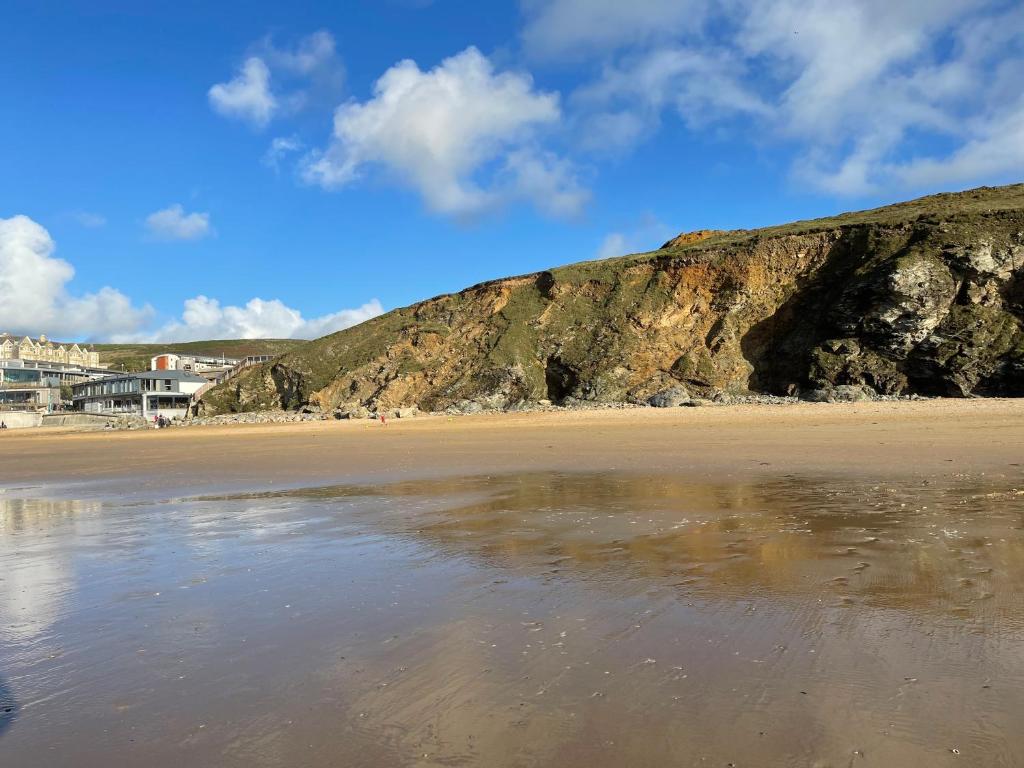 a view of a beach with a mountain at Beach Apartment, Watergate Bay, Newquay in Newquay