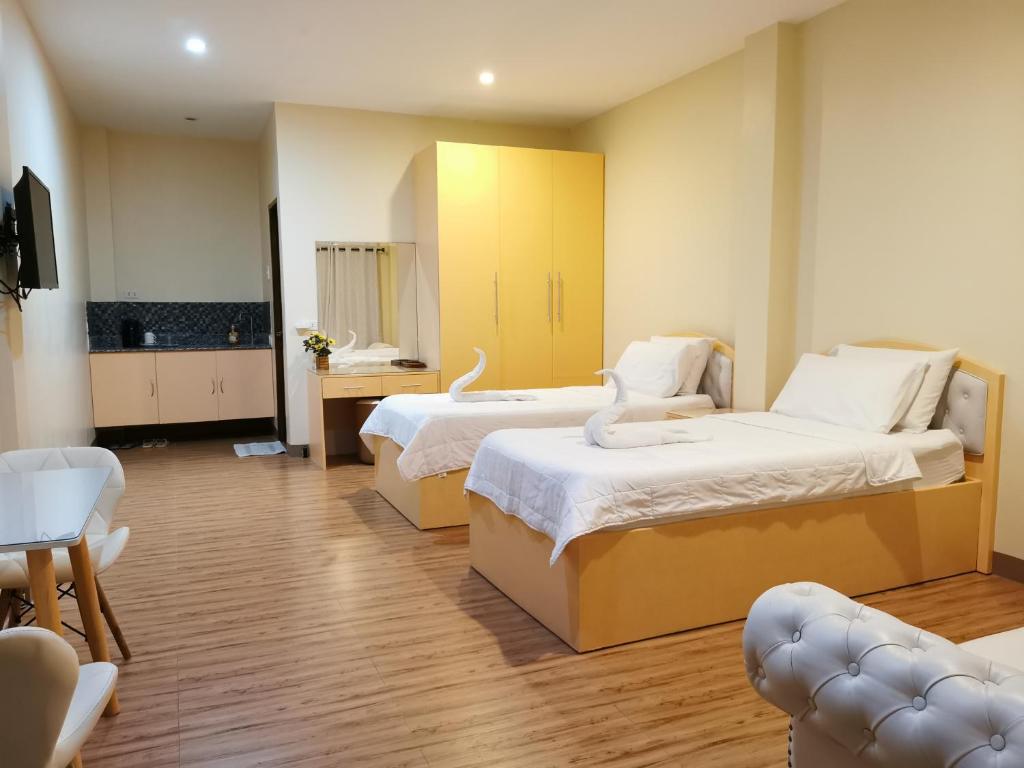 a hotel room with two beds and a television at Acrige Apartelle 2 pax Twin @ heart of Bogo City in Banban