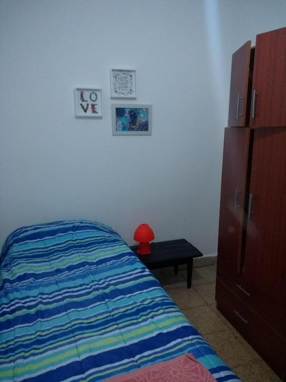 a bedroom with a bed and a dresser and a drawer at HA! 2 Resi para estudiantes in Córdoba