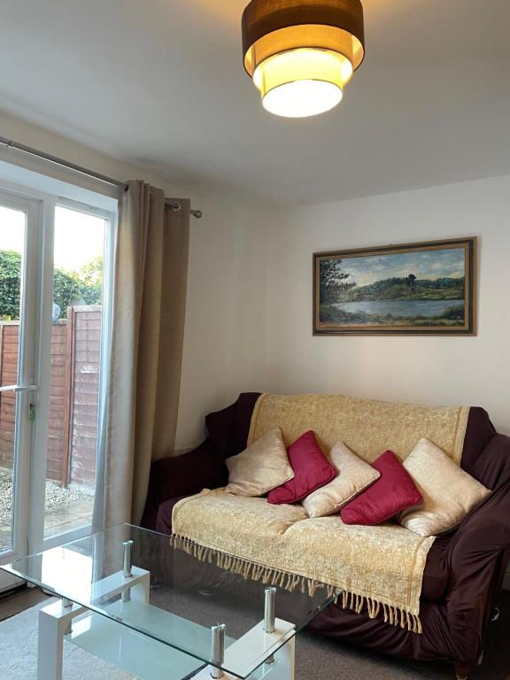 a living room with a couch and a glass table at Modern Home just off Glastonbury High Street in Glastonbury