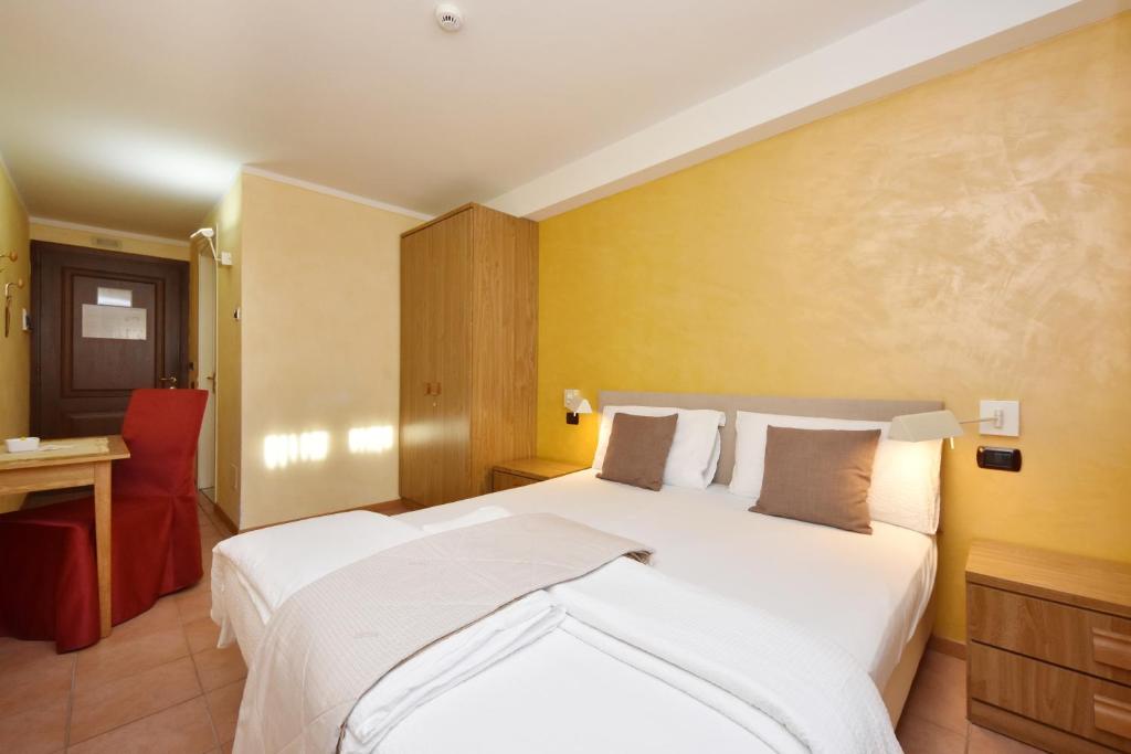 Postel nebo postele na pokoji v ubytování Albergo Negritella