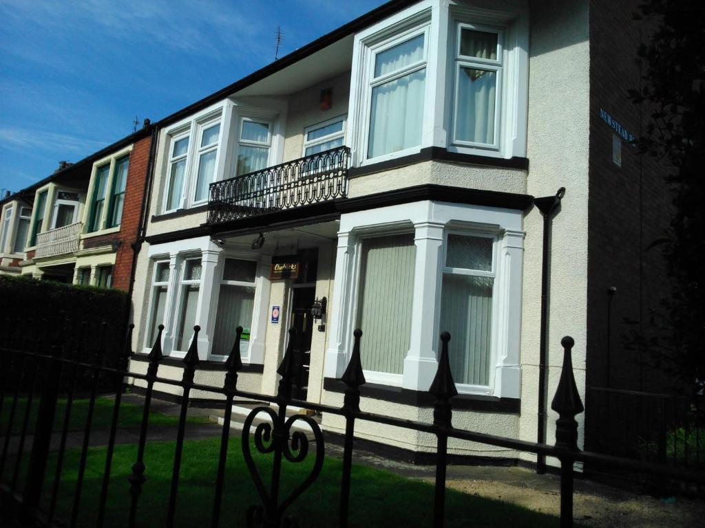 a house with a fence in front of it at Chadwick Guest House in Middlesbrough