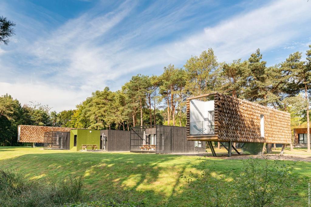 a house with a brick facade at Camping des Gayeulles in Rennes