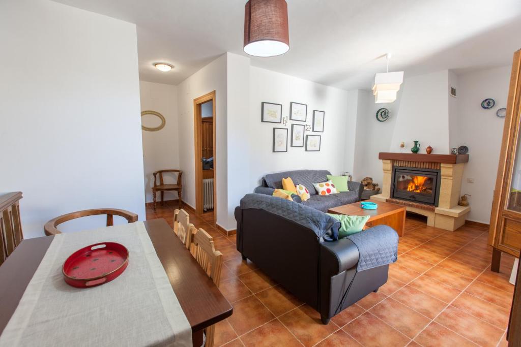 a living room with a couch and a table and a fireplace at Casa Martina Pampaneira in Pampaneira