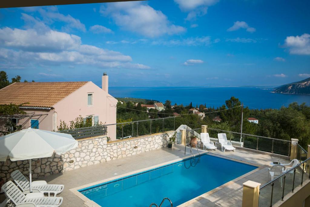 a villa with a swimming pool and a view at Villa Inspiration in Fiskardho