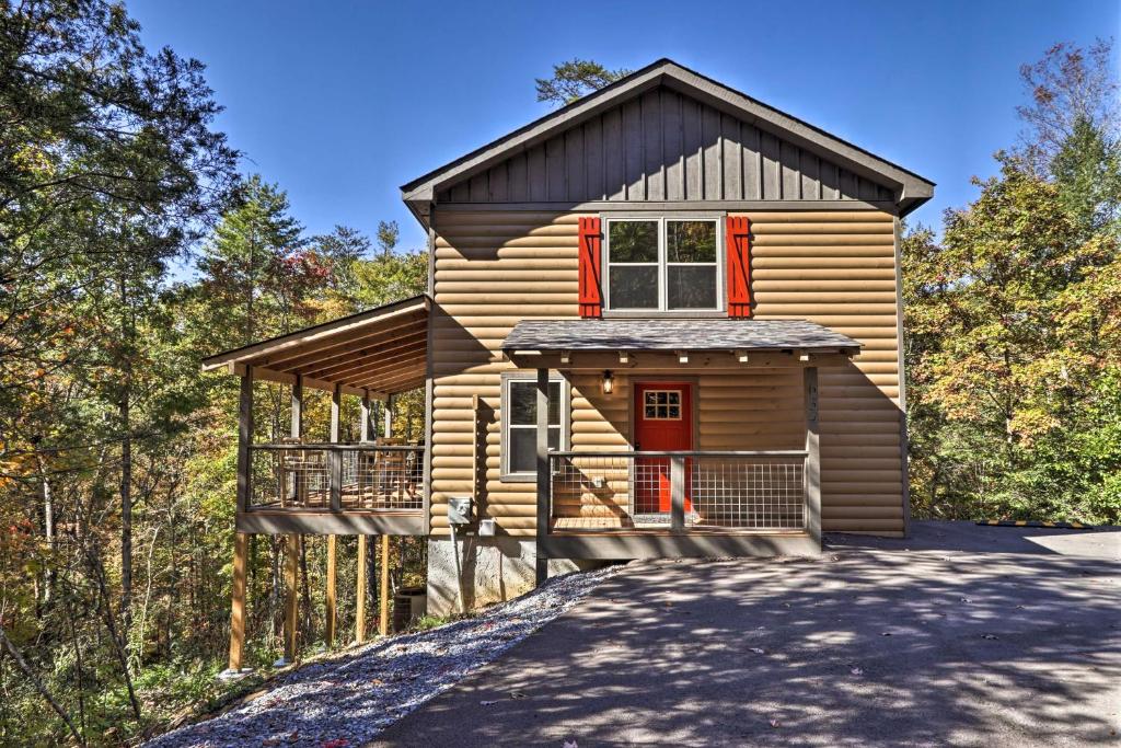 a tiny house in the woods with a driveway at Pigeon Forge Cabin with Hot Tub 1 Mi to Parkway in Pigeon Forge