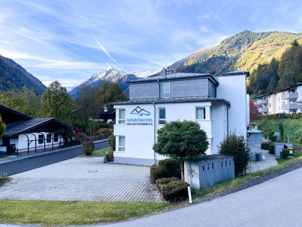 a white building on the side of a road at Der Gletscherblick by Alpin Rentals - incl Summercard in Kaprun