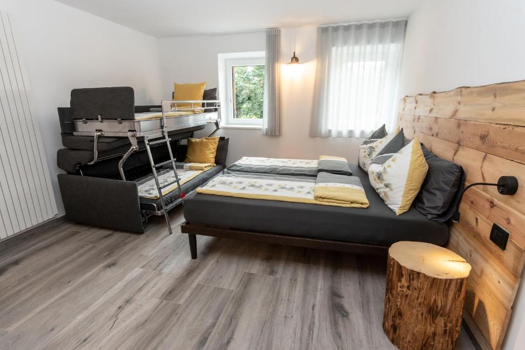 a bedroom with a bed and a desk in it at Agritur E-Cinque in Salorno